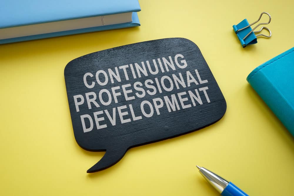 Continuing professional development memo on the yellow desk.