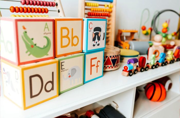 Set of kid toys on a white shelf